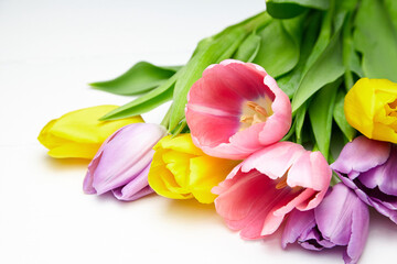 Tulip flowers on white wooden table. Colorful bouquet of spring tulip flowers