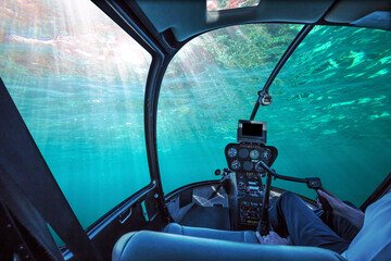 Underwater submarine ship cockpit in the blue ocean with sunbeams and copy space. Undersea background. Travel concept.
