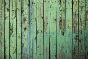 Fototapeta na wymiar Old wooden fence with green paint background texture.