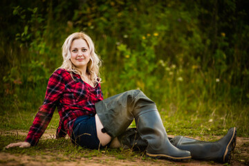 blonde girl in red shirt in nature, selective focus