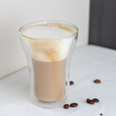 A double glass cup of cappuccino 