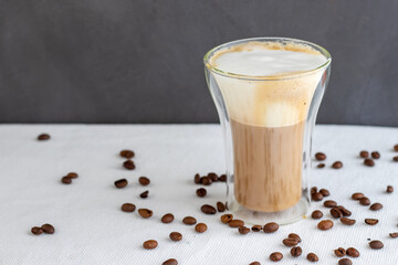 A double glass cup of cappuccino 