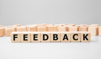 Word FEEDBACK made with wood building blocks