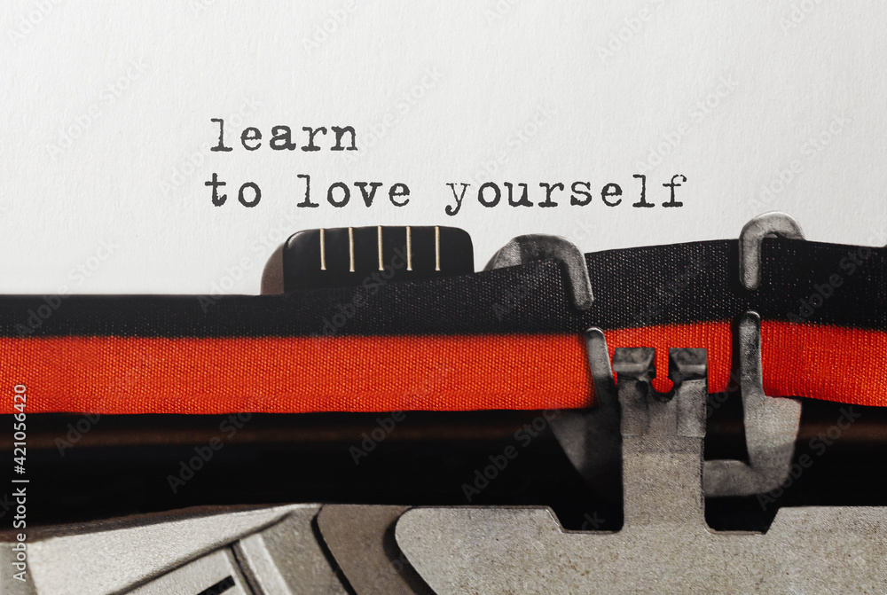 Poster text learn to love yourself typed on retro typewriter
