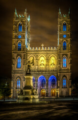 Fototapeta na wymiar Night view of the Notre-Dame Basilica and Place dArmes square, with visitors, in Montreal, Quebec, Canada