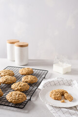 Delicious and crunchy oatmeal cookies and a cup of milk on white background. Copy space. Recipe, bakery menu, healthy dessert