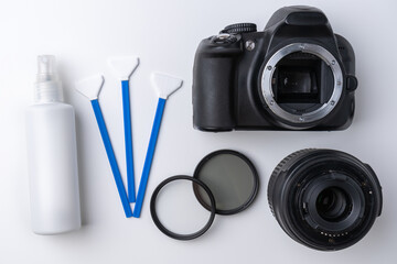 Professional tools and liquid for cleaning the matrix of a DSLR camera, on a white background