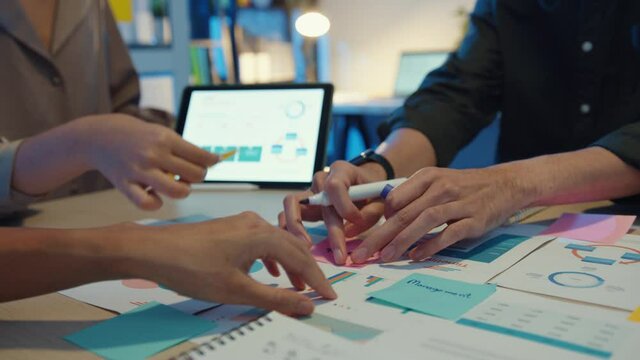 Close-up asia business people meeting plan analysis statistics brainstorm and header of team hold tablet pointing graph chart and employee take note. Finance strategy statistics success concept.