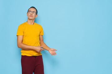 Cute guy in glasses gesticulating with his hands 