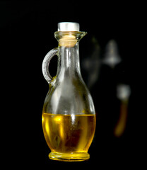 vegetable oil in a glass flask on a black background