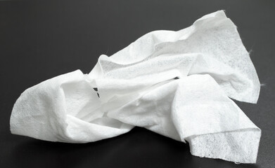 crumpled white paper on dark background