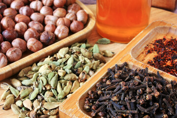 Cardamom seeds, clove sticks and honey