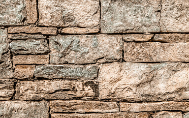 brown stone wall closeup, textured pattern, natural background