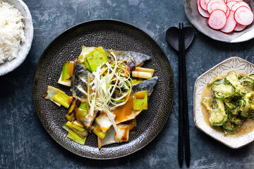 Japanese meal with miso mackerel, cucumber salads and pickled radishes