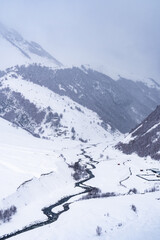 Fototapeta na wymiar Snowy winter mountains in Georgia. Caucasus Mountains