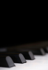 Black and white piano keys side view with shallow depth of field. The black keys are called sharps or flats. Focus on the second black key from the left © Henk Vrieselaar