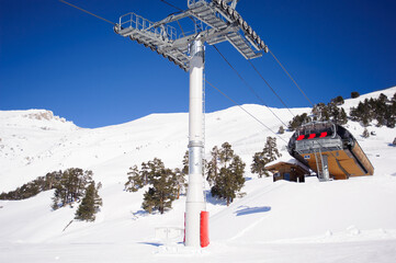 Fototapeta premium Winter mountains panorama with ski slopes and ski lifts.