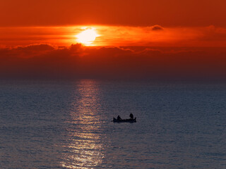 Fototapeta premium Sunrise and fishing boat silhouette at Black Sea