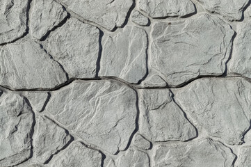 Grey stone wall background with relief.