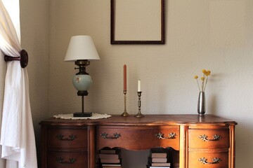 Antique and vintage style wooden desk decor. Empty picture frame, mock up frame