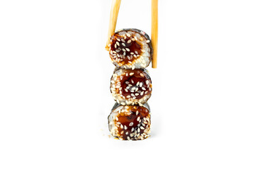 take an unagi maki rolls with bamboo chopsticks on white background, asian food, japanese cuisine