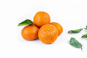 Ripe fresh juicy tangerines with leaves on white background