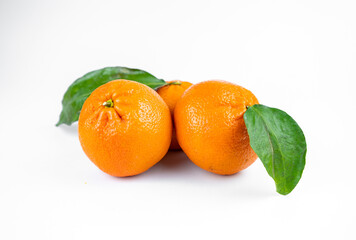 Ripe fresh juicy tangerines with leaves on white background