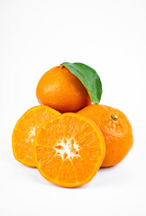Ripe fresh juicy tangerines with leaves on white background