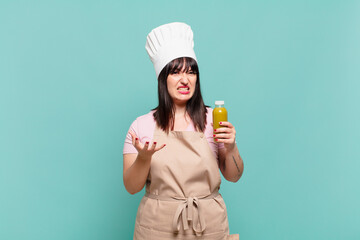 young chef woman looking angry, annoyed and frustrated screaming wtf or what’s wrong with you