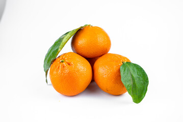 Ripe fresh juicy tangerines with leaves on white background
