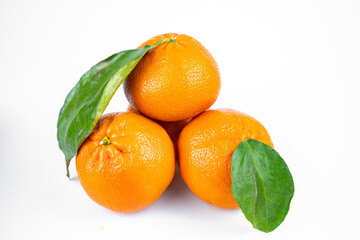 Ripe fresh juicy tangerines with leaves on white background