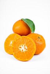 Ripe fresh juicy tangerines with leaves on white background