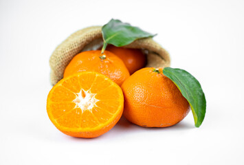 Ripe fresh juicy tangerines with leaves on white background