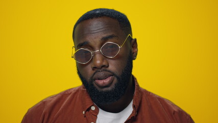 Closeup positive african american man waving head yes on yellow background.