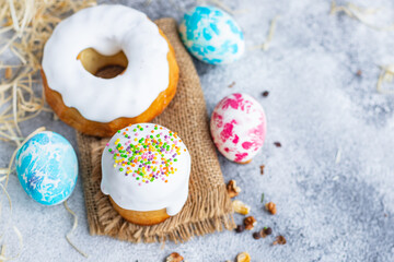 Easter festive cakes holidays colored easter eggs festive table setting. traditional baked goods sweet dessert christian holiday  meal top view copy space rustic food background 