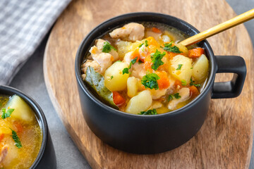 Chicken stew with potatoes, zucchini, and carrots in a bowl