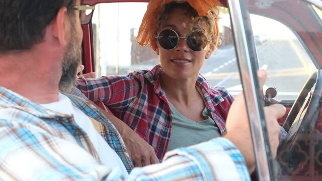 Caucasian Man And Woman Sit Down Inside A Car Speaking And Enjoying Together The Travel - Young Adult Couple Hipster Style In Travel Lifestyle Leisure Activity Sitting - Two Friends People  Transport 