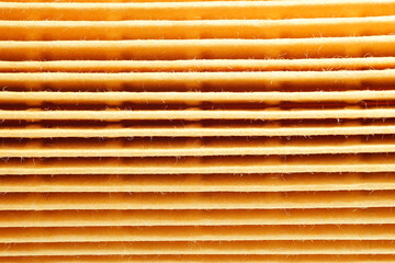 High quality filter element close-up. Filtered yellow paper macro photography. Oil filter element.