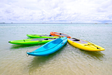 Rental Colorful Paddle Boards and Kayaks. on beach of Moorea, Tahiti.  French Polynesia. Tropical paradise.