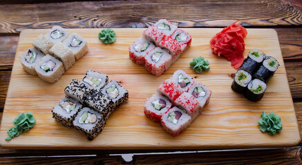 Set of sushi rolls on a wooden board