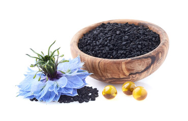Black cumin seeds with nigella sativa flower on white background
