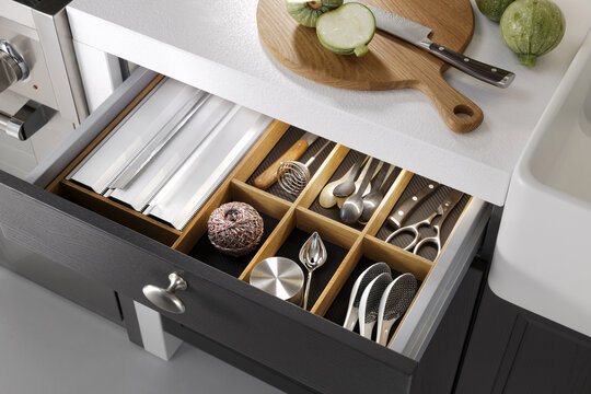 Modern kitchen, Open drawers, Set of cutlery trays in kitchen drawer. Solid oak wood cutlery drawer inserts.