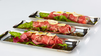 The asparagus covered in roasted beef. Mediterranean cuisine. Shallow dof