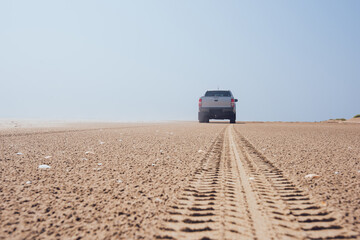 Car on empty off road of desert