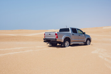 Car on sandy off road in desert