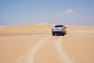 Fototapeta na wymiar Pickup on sandy dunes in Ustyurt Nature Reserve