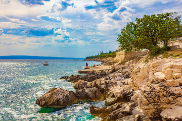 Wonderful turquoise and rocky beach and promenade Novi Vinodolski Croatia.