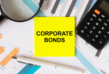 Yellow sticker with text Corporate Bonds with calculator white pen magnifying glass on the diagrams