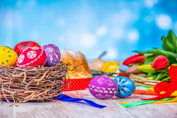 Painted Eggs In Basket With Tulips On Natural Wooden Plank