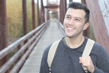 Ethnic man crossing wooden footbridge  